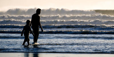 Father and son walking on the beach