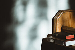 Bible and hymn book on pew