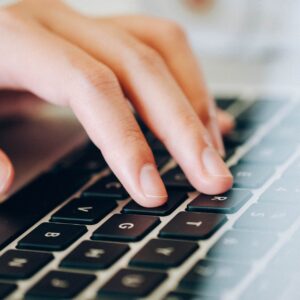 Someone typing on a laptop