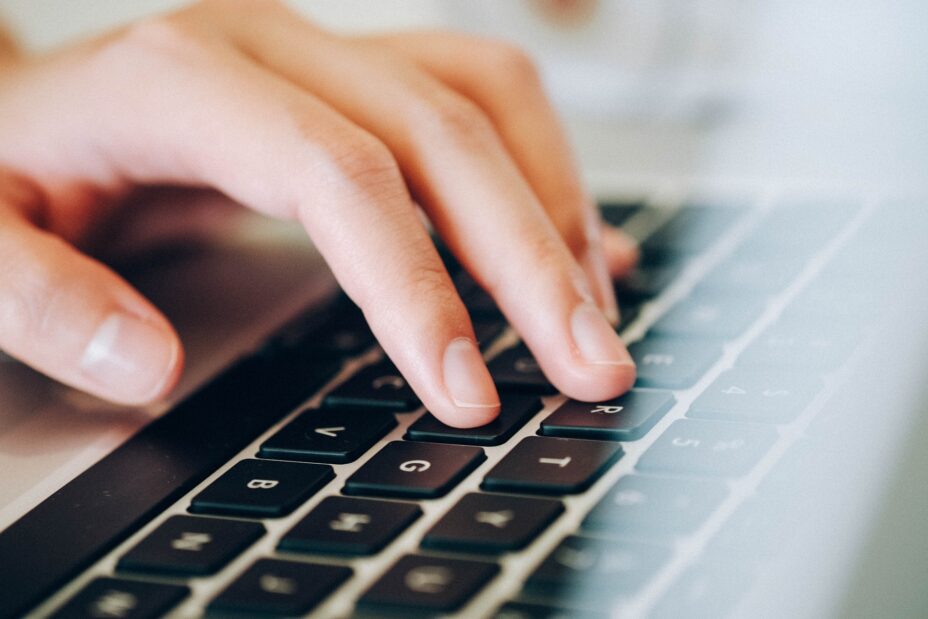 Someone typing on a laptop