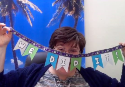 Rachel Turner holds up a banner: we did it