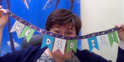 Rachel Turner holds up a banner: we did it