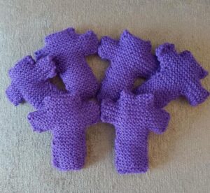 seven purple knitted crosses