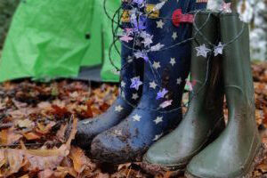 Wellington boots next to a tent in woodland