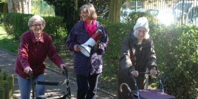 BRF's Anna Chaplaincy Pioneer with two older ladies using walking frames on an Anna Chaplaincy sponsored walk