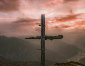 A wooden cross overlooking mountains