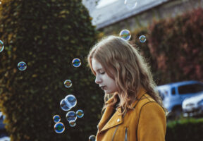 A child playing with bubbles