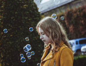 A child playing with bubbles