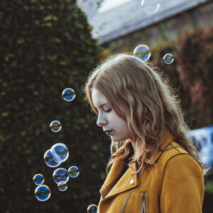 A child playing with bubbles