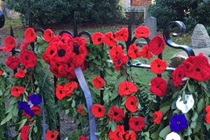 Church gate decorated with knitted poppies