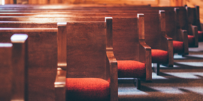 Wooden pews with red seating