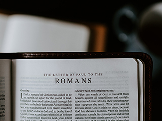 Bible open to the letter to Romans