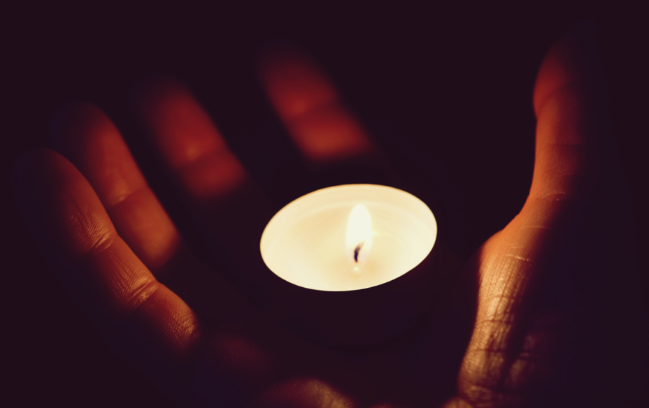 Hand holding a candle